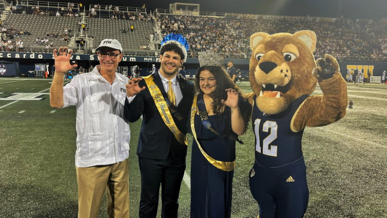 Interim President Dr. Kenneth A. Jessell, Homecoming King Lucas Zamora, Homecoming Queen Amanda Taylor, and school mascot Roary pose for a picture on the field | Priscilla Pozo, PantherNOW.