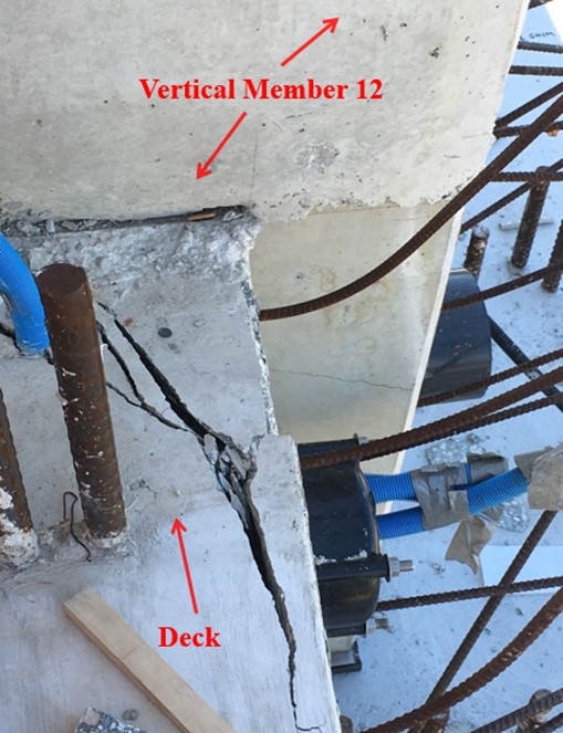 This photo illustrates the condition of the cracks after the move of the main span that occurred on March 10, 2018. Photo taken on March 14, 2018 at 1:50 pm shows east side directly adjacent to vertical member 12, top of deck looking down, view of crack. Labels added to photo by the NTSB. Photo courtesy of NTSB.